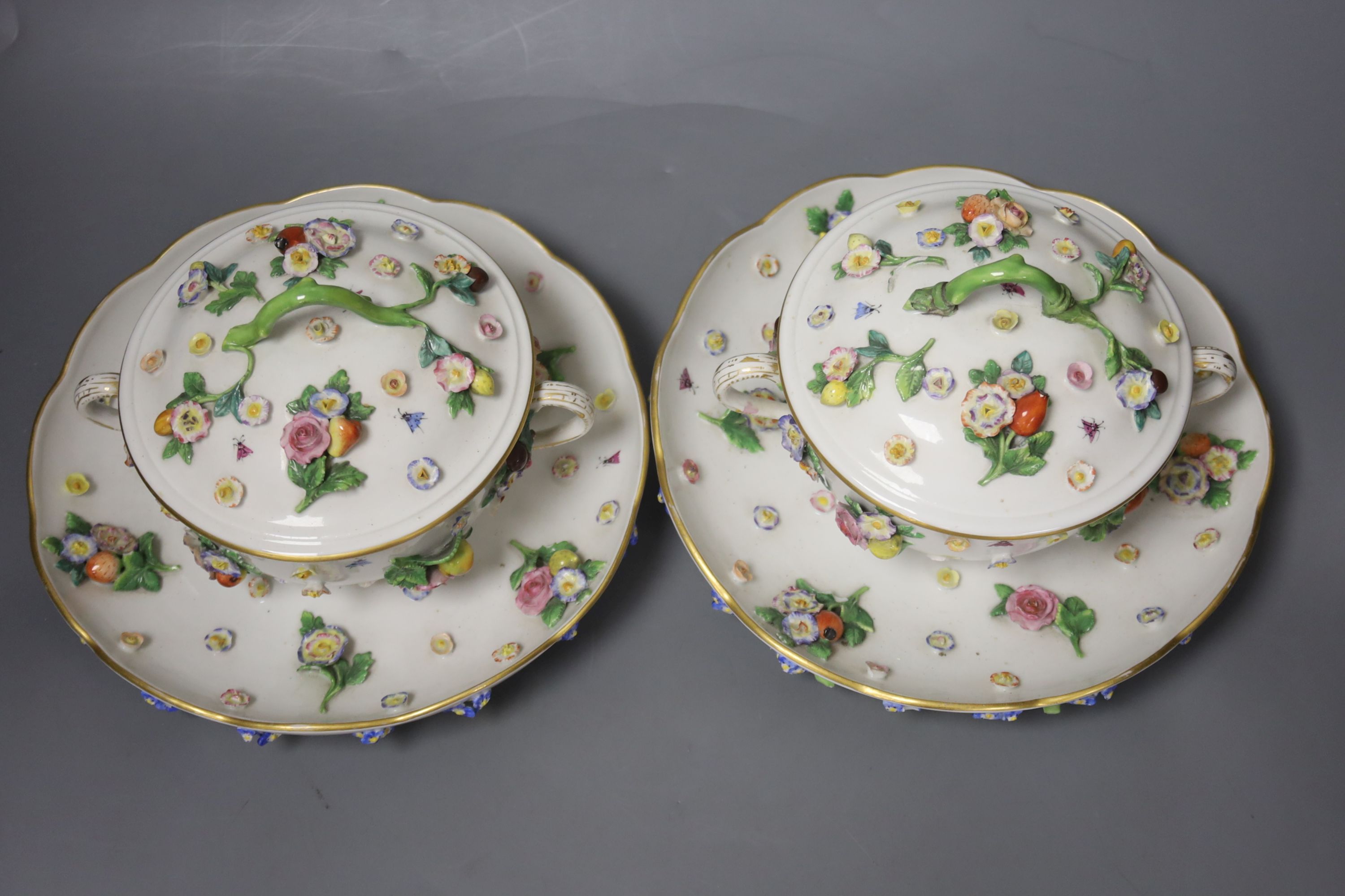 A pair of 19th century Meissen two handled ecuelles and covers, stands width 21cm